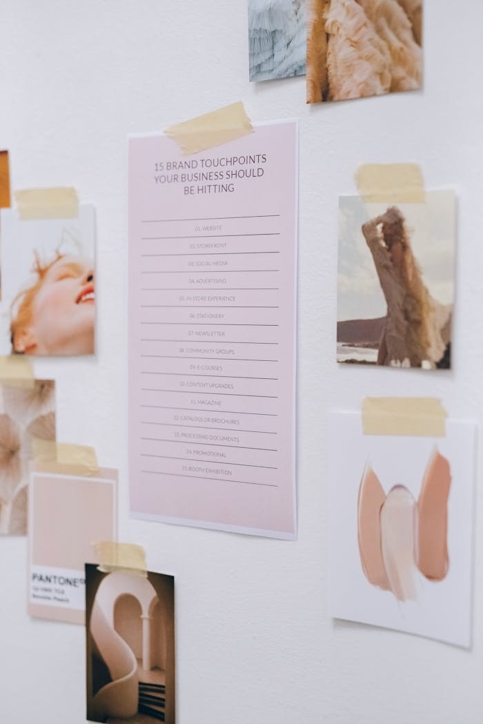 A creative mood board with business touchpoints and inspirational images taped to a white wall.